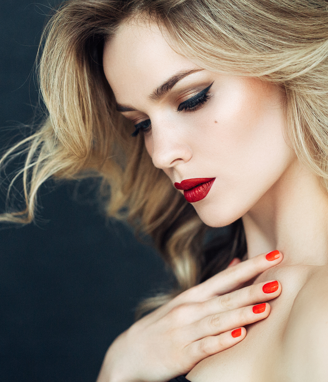 blonde woman with red nail polish and lipstick