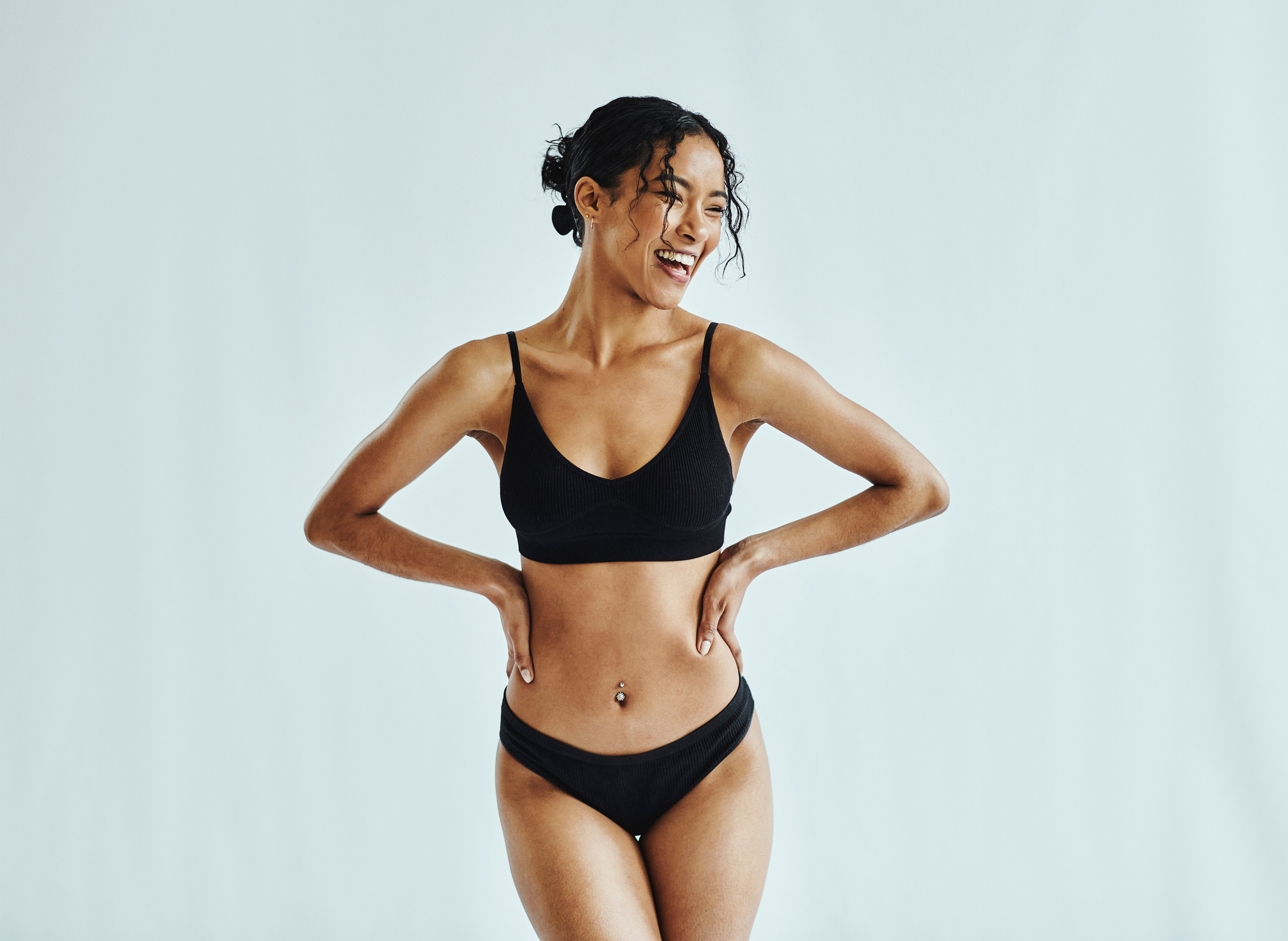 Woman in black undergarments smiling