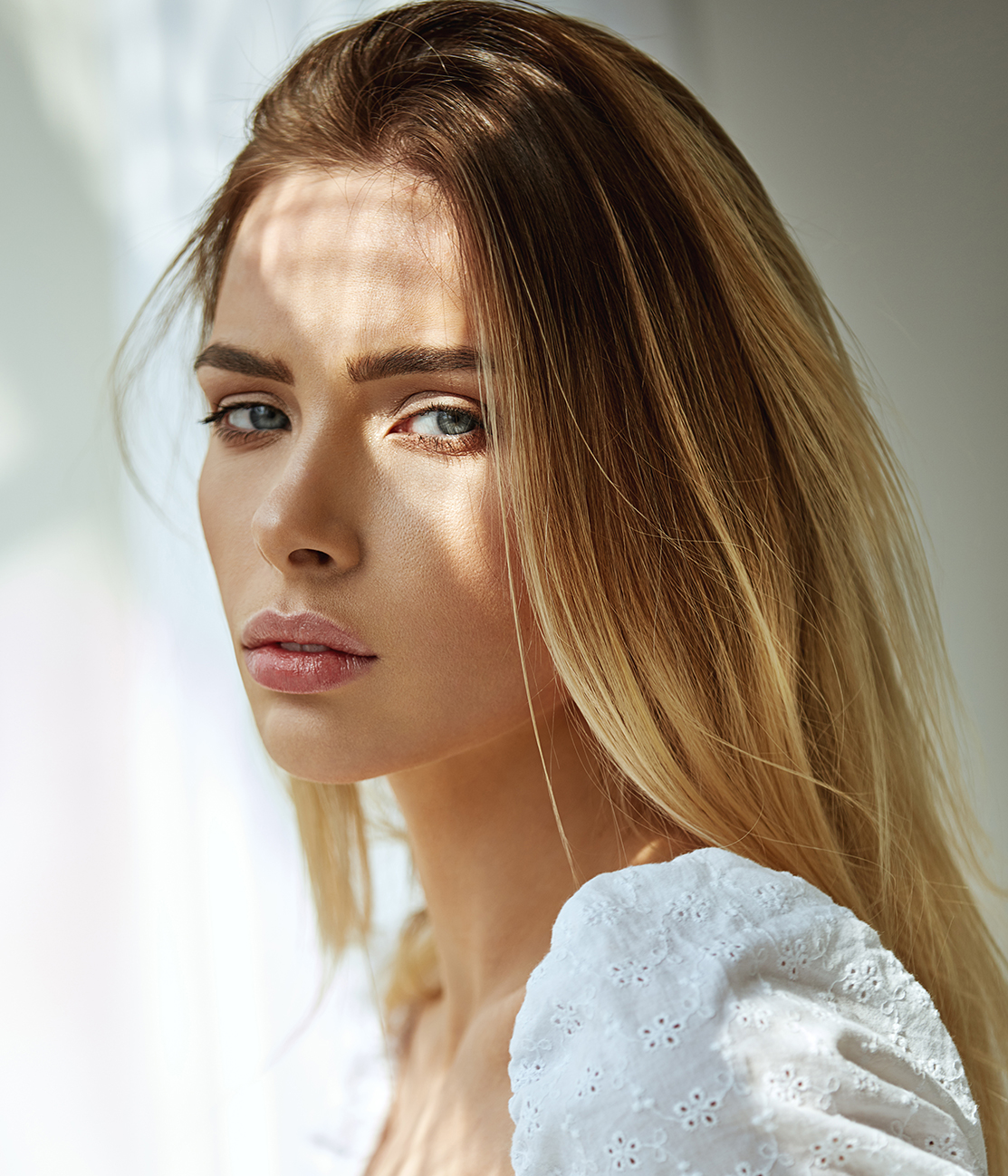 blonde woman looking towards camera